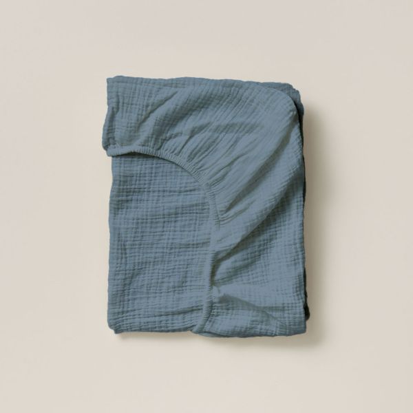 Crib fitted sheet in 45x90 size in denim blue made from organic muslin cotton from Petite Amélie